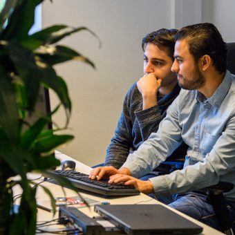 Image of two collaborating Signicats at the Rotterdam office